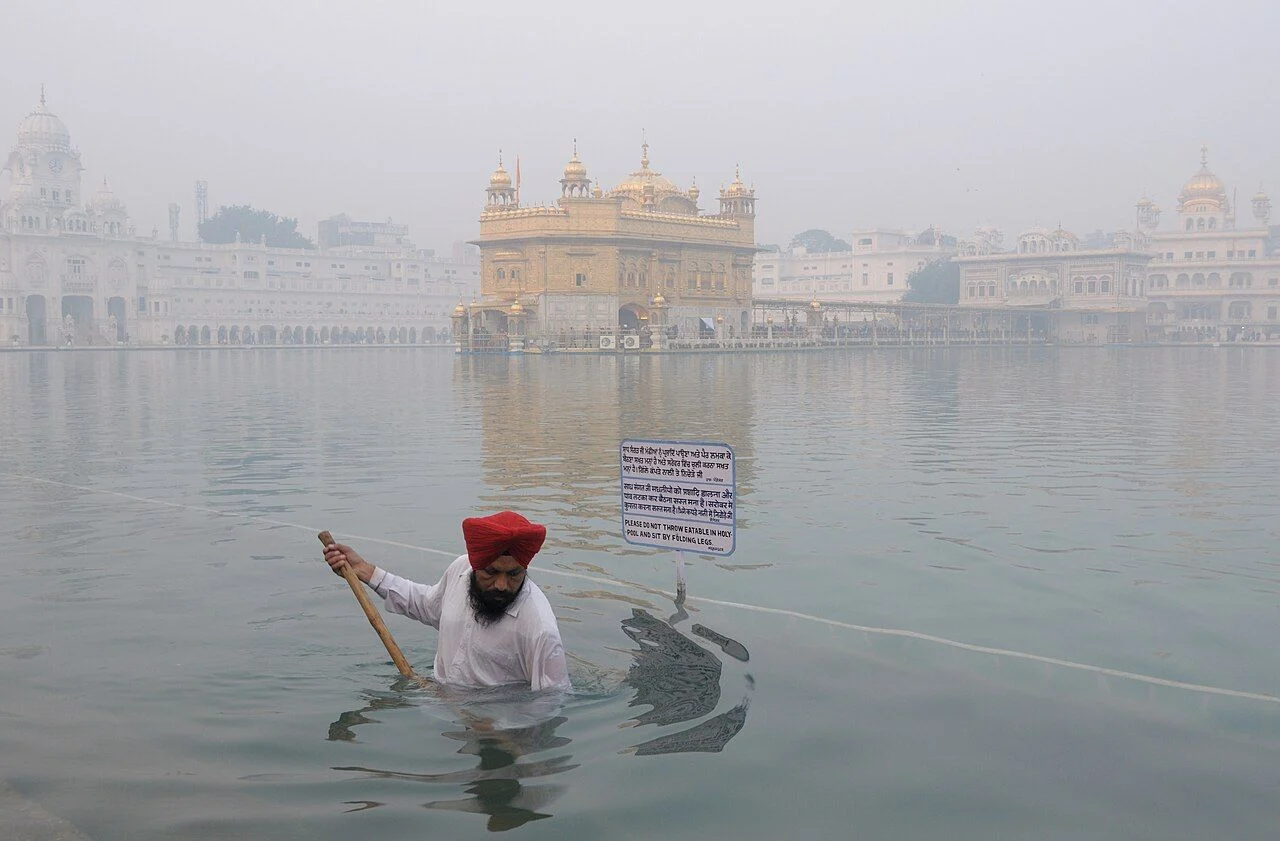 Golden Temple Harmandir Sahib in Amritsar reflected in the Amrit Sarovar pool