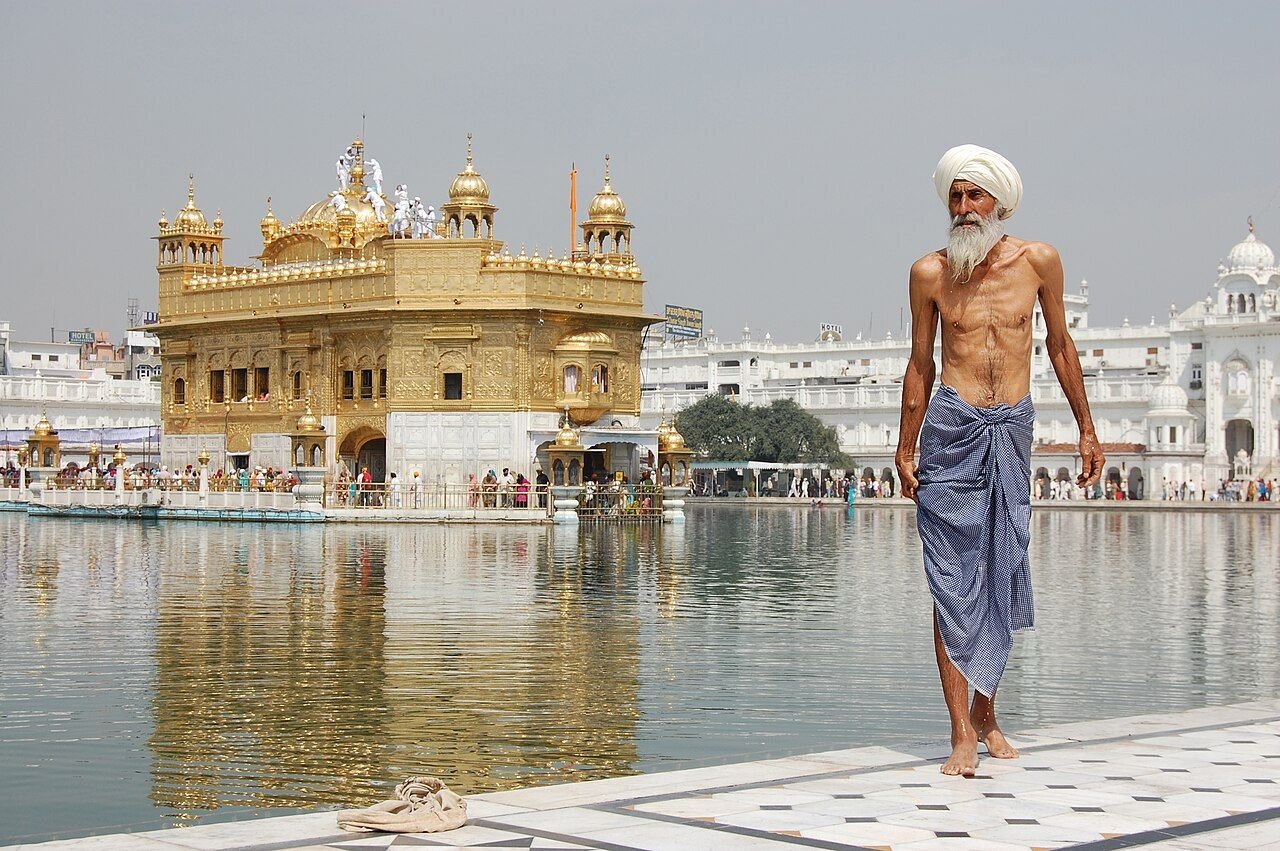A Sikh pilgrim beside the sacred pool at the Golden Temple in Amritsar
