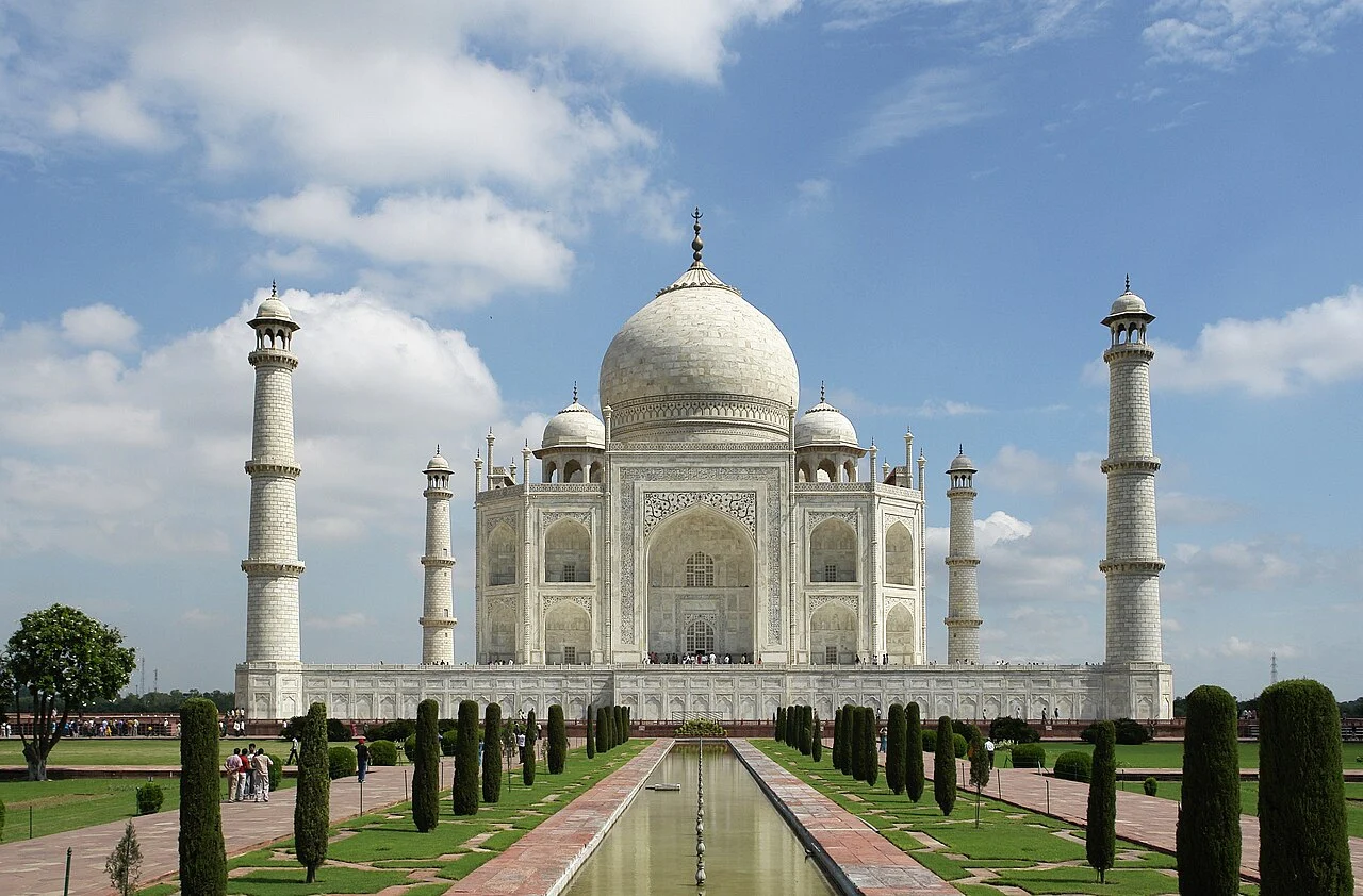 The Taj Mahal in Agra seen from across the central water channel, with its white marble dome and four minarets